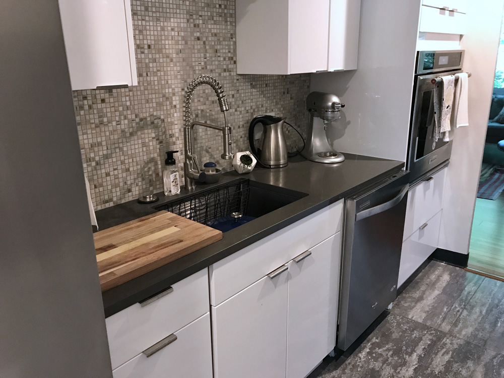 new sink with black kitchen countertop