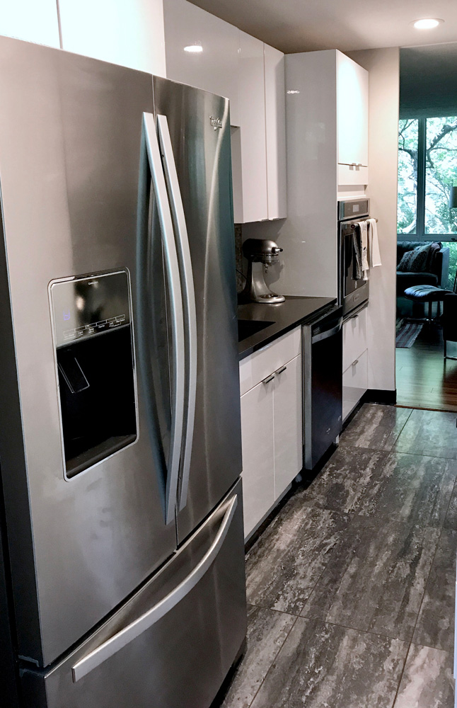 silver refrigerator and white kitchen cabinets