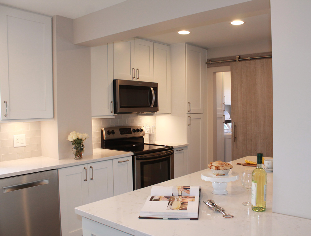 white kitchen with stainless steel appliances