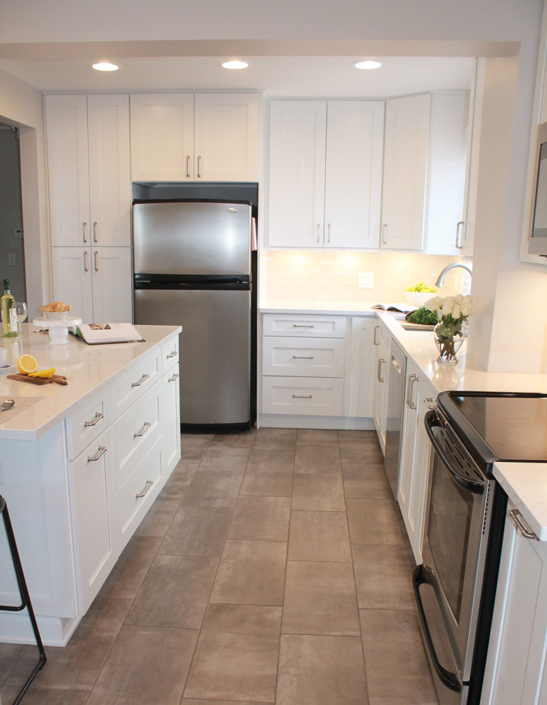 white kitchen design with stainless steel refrigerator