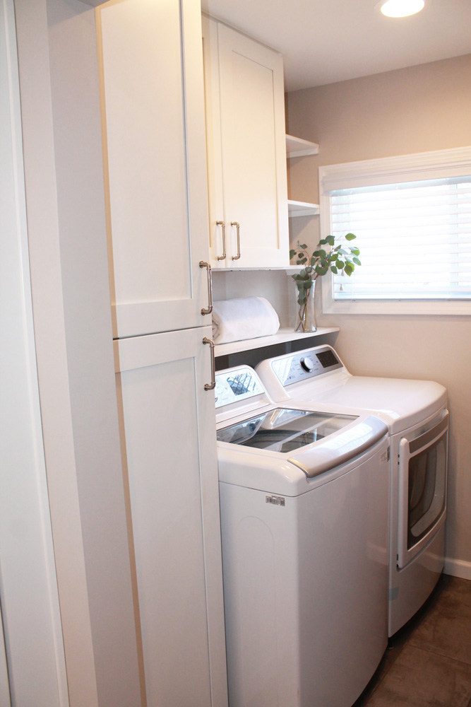 laundry room with white cabinets