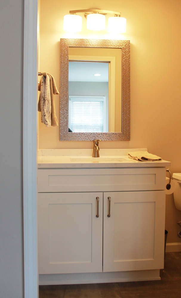 bathroom with white cabinets
