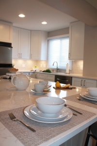 white kitchen table with dishes and silverware