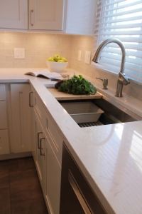 Kitchen sink with white kitchen cabinets and countertop