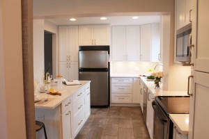full kitchen with white cabinets and a white kitchen island