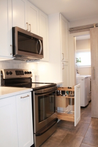 new white kitchen cabinets with a silver stove
