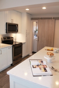 white kitchen with stainless steel microwave and stove